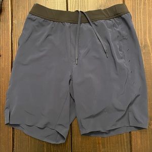 Ten Thousand Interval shorts with liner. 9”. Navy . Large
